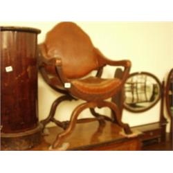 Late Victorian mahogany open armed saddle chair with leather upholstery on turned H stretcher…