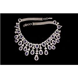 NECKLACE: [1] 18kwg sapphire and dia fringe style necklace. Set with  (28) 7.00mm x 5.00mm oval sapp