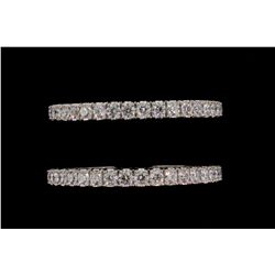 BRACELETS: [2] 18kwg bangles. Each is prong set with (41) 4.80mm - 5.00mm rbc dias VS2-SI2 clarity a