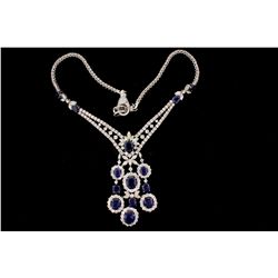 NECKLACE: 14kwg sapphire and dia necklace 21" long. (15) oval faceted sapphires 7.00mm x 5.00mm - 12