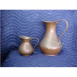 Pair of hammered copper pitchers