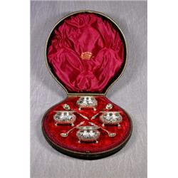 A Cased Set of 4 Silver Plated Salt on 3 Ball Feet and 4 Apostle Spoons. In Original Red Velvet L...