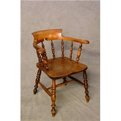 A 19th Century Elm Smokers Bow Armchair with Turned Spindle Supports and Legs. Est. 100-150...