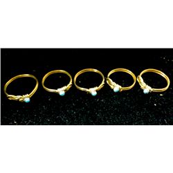 Five brass wire and turquoise rings