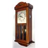 Image 1 : Oak cased chiming wall clock with visible pendulum and bevelled glass panels…