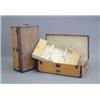 Image 1 : A matching pair of Louis Vuitton trunks, with studded tan leather bound orange canvas, opening to...
