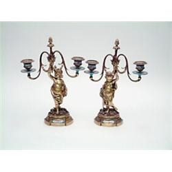 A pair of 19th century French gilt bronze and porcelain mounted candelabra, figural stems in the...