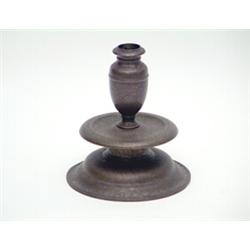 A 17th century Veneto-Saracenic brass candlestick, with broad mid-drip pan, finely engraved with...