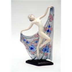 A Goldscheider porcelain figure of a dancing nude lady holding a floral patternd drape on diamond...