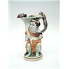 Image 1 : An early 19th century Prattware bacchus jug, with catfish head spout and otter handle with 2 figu...