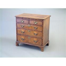 A George I cross banded walnut chest, fitted brushing slide, 2 short and 3 graduated long drawers...