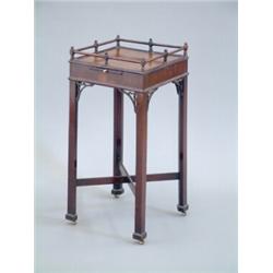 A Chippendale mahogany urn stand, with single turned gallery, square top, slide and fretwork brac...