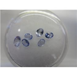 Gem jar filled with oval cut tanzanites