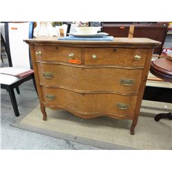 Antique dresser with curved front