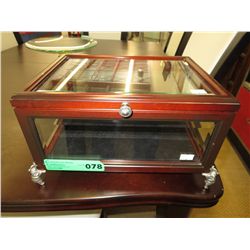 Glass display case with elegant elephant feet