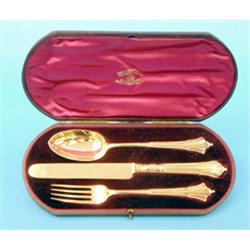 A Victorian 3 piece silver gilt christening set, comprising:- albany pattern knife spoon and fork...