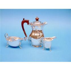A George V silver hot water pot, a cream jug and a plated sauceboat £100-150...