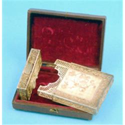 A Chinese filigree card case, applied with dragons and flowers, in leather case £60-80...