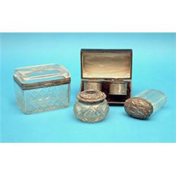 A cased pair of silver napkin rings, two silver mounted glass toilet jars and a cut glass casket...