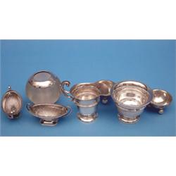 An Edwardian silver mounted glass match tidy, a silver cream jug and sugar bowl, a pair of boat s...