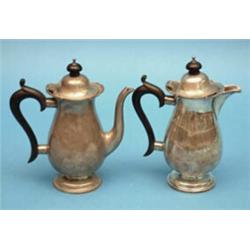 A pair of George V silver cafe au lait pots, with ebonised handles 20oz (gross) £100-150...