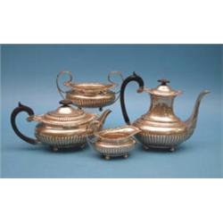 A late Victorian 4-piece silver tea and coffee set, of demi-fluted oval form with gadroon and fol...