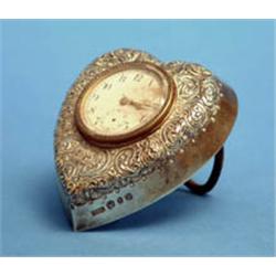 A late Victorian silver desk timepiece, heart shaped with foliate scroll engraving 4ins £100-150...