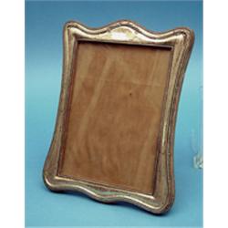 A George V silver mounted photograph frame, 10ins £120-150...
