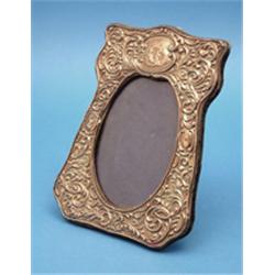A George V floral repousse silver photograph frame, Chester 1932, 8ins £100-150...