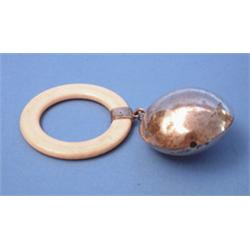 A George V silver rattle, of ivory ring teether £80-120...