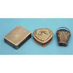 An Asprey silver vesta case, with sprung lid; a heart shaped pill box and a Continental basket pi...