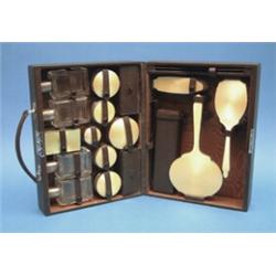 A George V 15-piece silver mounted toilet set, with yellow enamelled mounts, in fitted leather tr...