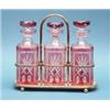 Image 1 : A plated tantalus, fitted with 3 ruby overlaid glass decanters £300-400...