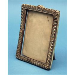 A silver mounted rectangular photo frame and a cased set of 12 coffee spoons 6.5ins £100-150...