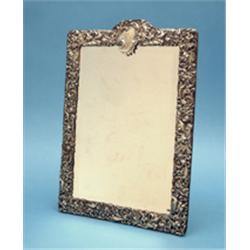 A Victorian silver mounted toilet mirror, decorated with birds and flowering scrolls, 17ins., Mak...