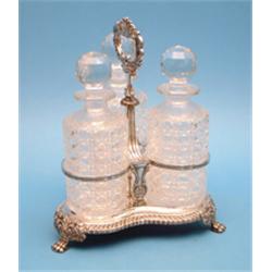 An Old Sheffield plate decanter stand, fitted with 3 cut glass decanters, on lions paw feet £200-...