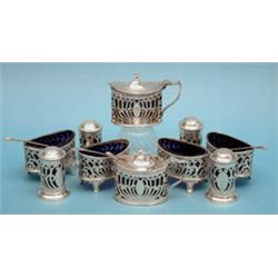 A late Victorian 10-piece silver condiment set, comprising 4 oval salts, 4 peppers and 2 drum mus...