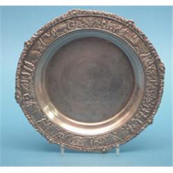 A Chinese silver salver, the border decorated in relief with figures in a continuous landscape, o...