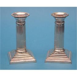 A pair of plated dwarf candlesticks, with fluted stems and stepped square bases, 5.75ins., togeth...