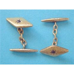 A pair of 15ct gold lozenge shaped cufflinks, each gypsy set with a single sapphire £70-100...