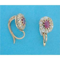 A pair of gold diamond and ruby oval cluster earrings. £200-300...