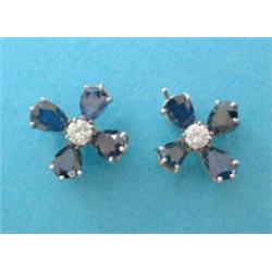 A pair of white gold sapphire and diamond flowerhead earrings, each set 4 pear shaped sapphires a...