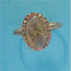 A George III gold memorial ring, with oval plaited hair compartment bordered by a row of small ga...