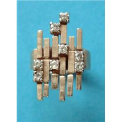 A 1970's gold dress ring, of abstract form set with 8 diamonds £100-150...