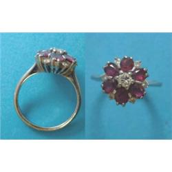 An 18ct white gold, ruby and diamond flowerhead cluster ring £200-300...