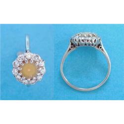 A platinum diamond & pearl circular cluster ring, (the pearl a.f) £100-150...