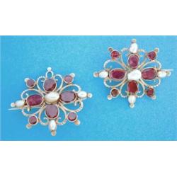 A pair of Eastern pierced work brooches set flat cut garnets and baroque pearls £260-300...