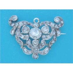 A 19th century gold pierced work scroll design brooch, set rose cut diamonds £600-800...