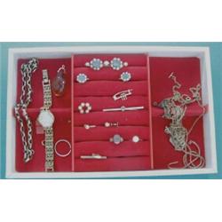 A modern cream leather jewellery case, the contents including gold earrings, rings etc £80-120...