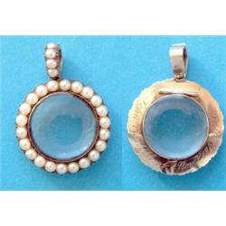 A Victorian gold double sided circular locket pendant, the frame and loop set split pearls £100-1...